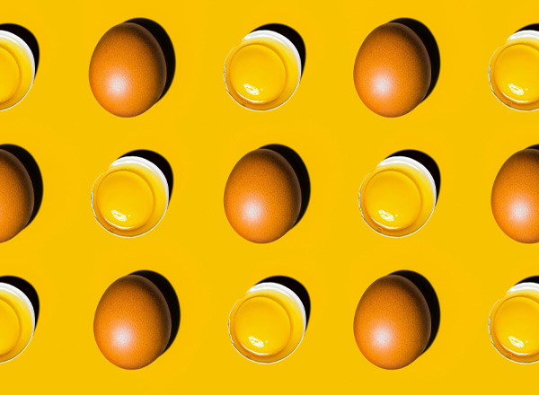 Eine wiederholte Anordnung von Eiern und Schalen mit Eigelb auf einem leuchtend gelben Hintergrund. Jedes Ei ist braun, während die Schalen transparente Ränder zeigen, die das gelbe Eigelb präsentieren.