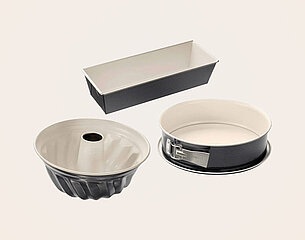 Drei Backformen sind abgebildet: eine Gugelhupfform, eine Kastenform und eine Springform. Die Formen haben matte Oberflächen in Schwarz und Weiß und sind für verschiedene Backzwecke geeignet.